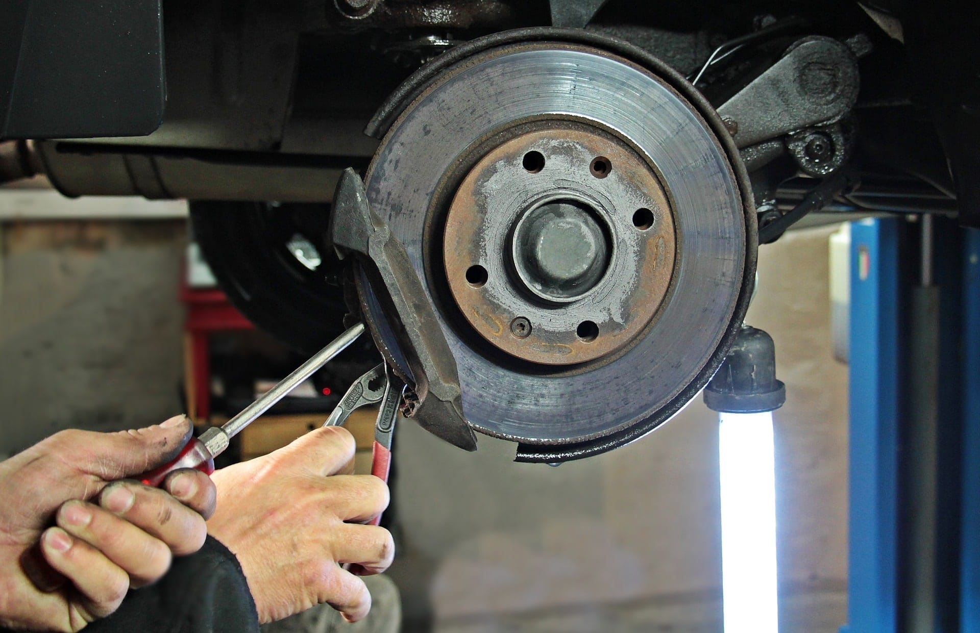 mechanic being exposed to asbestos while repairing brakes on vehicle