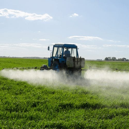 Man-on-Tractor-Spraying-Herbacide-Paraquat - Ferraro Law Firm Man of Tractor Spraying Herbicide Paraquat